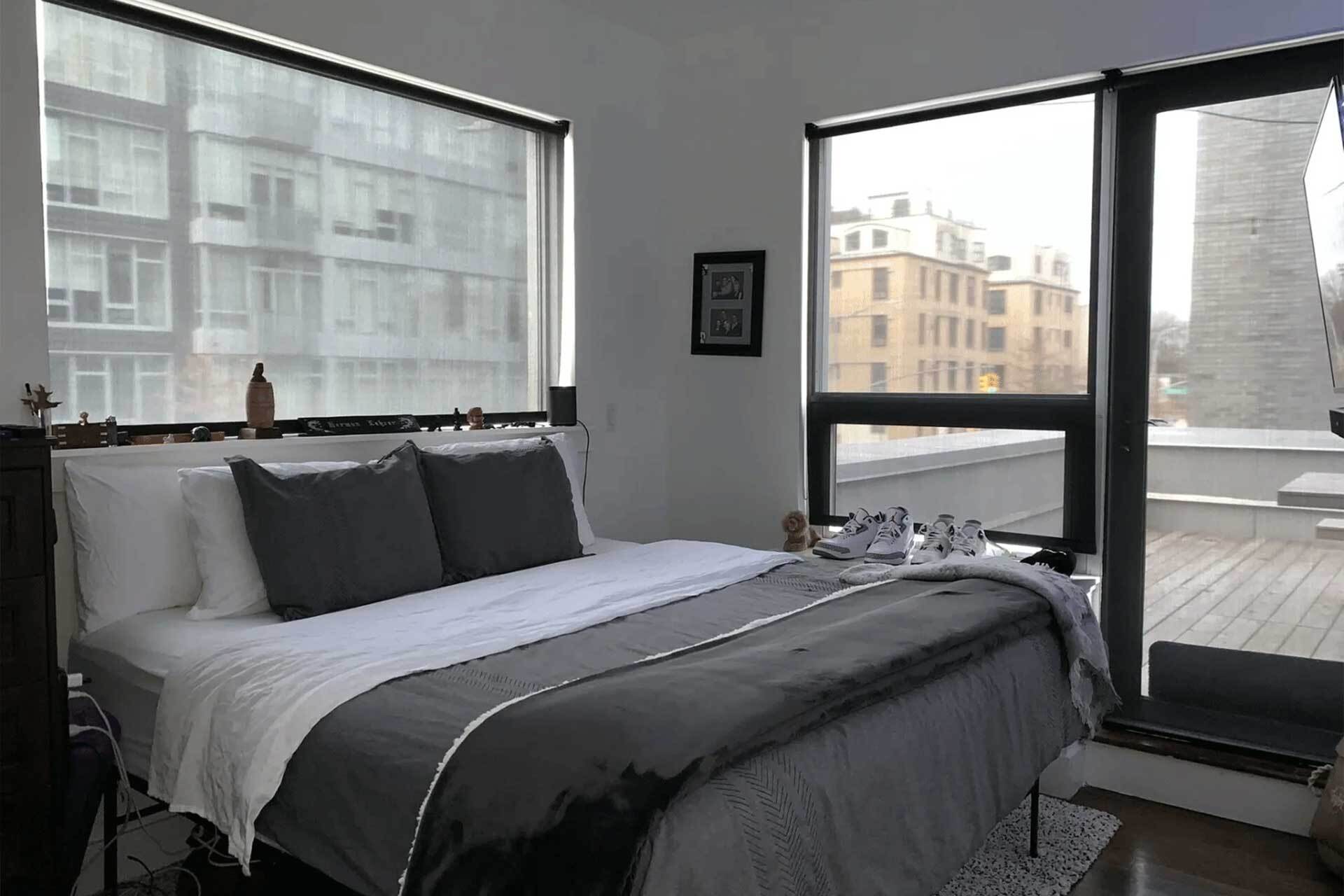 a bedroom with a large bed and a large window