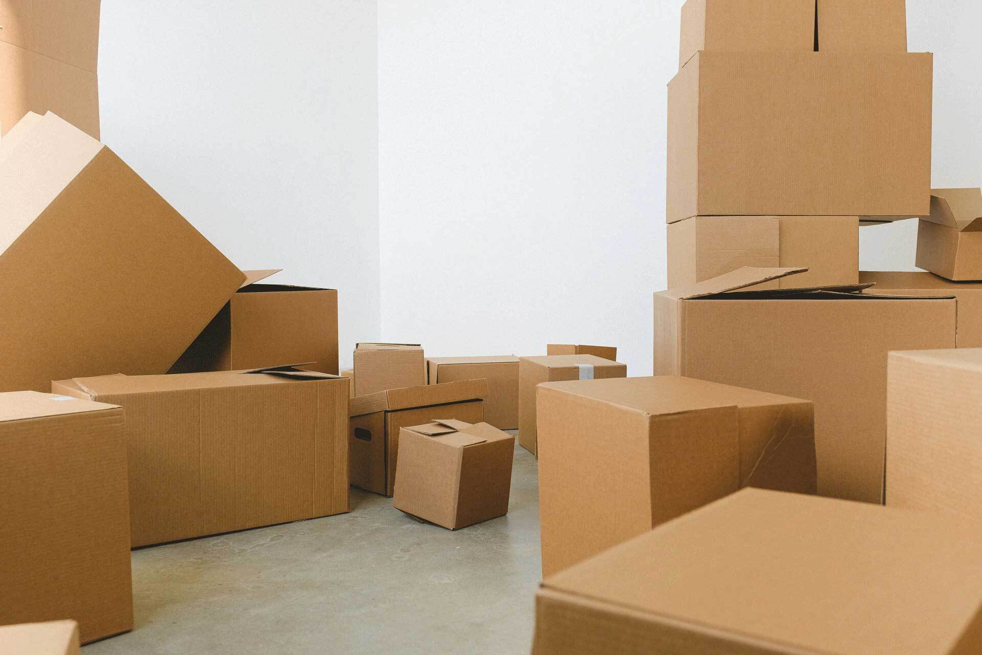 a room filled with lots of cardboard boxes stacked on top of each other .